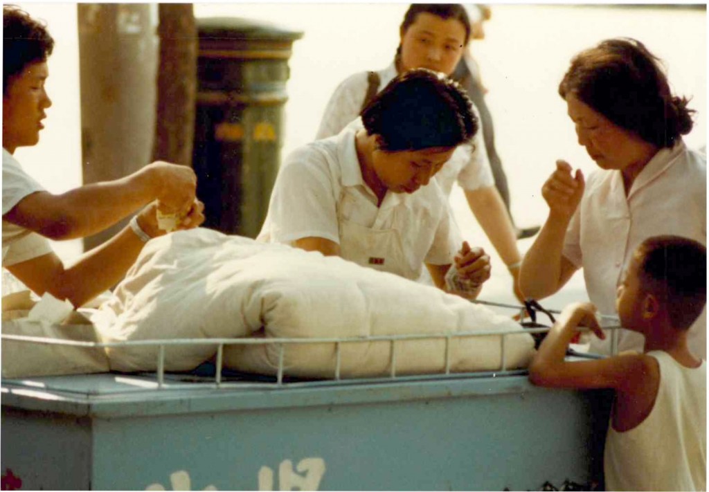  A scene at a street of Beijing in June 1981 where ice cream was sold to pedestrians. The ice cream vendor was very popular and many would stand in line to buy an ice cream. It seemed this was one early and first attempt to allow private business.